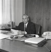 Chancellor Glenn S. Dumke sits at his desk