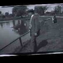 A young man standing next to Soutside Park lake