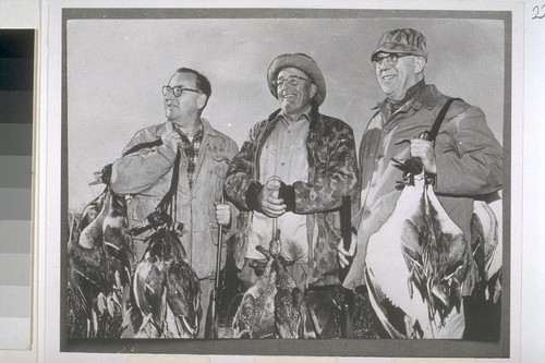 Warren with geese on Wally Lynn's ranch near Colusa. [Left to right]: Edmund G. Brown, Wallace Lynn, Earl Warren