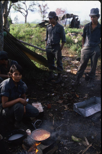 A female Contra soldier cooks for the camp, Nicaragua, 1983