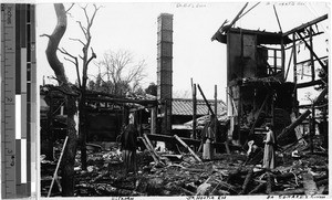 Maryknoll Sisters standing among remains of their fire damaged convent, Zeze, Japan, February 2, 1938