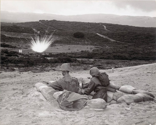 Photograph of two soldiers in a foxhole