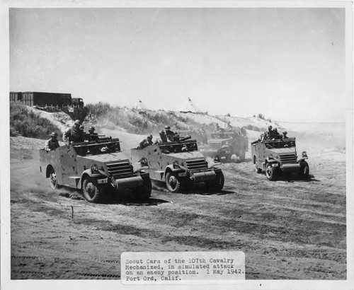 Scout cars of the 107th Cavalry Mechanized, in simulated attack on an enemy position