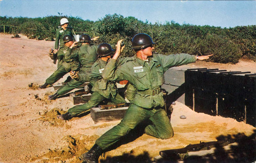 Photographic postcard of soldiers training with hand grenades