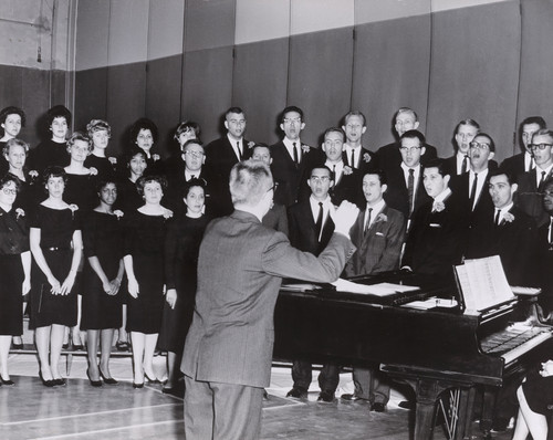 Photograph of a choral group with Lee Kjelson, Associate Professor of Music