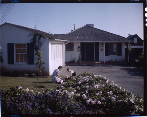 [Unidentified residential exteriors and landscaping]. Number 12022. Woman and boy