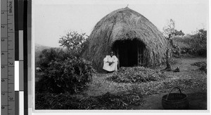 Man sitting outside a hut, Uganda, Africa, ca. 1920-1940