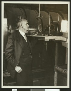 Dr. Albert Abraham Michelson, the first American to receive the Nobel Prize in sciences, showing a small, metal instrument, ca.1930