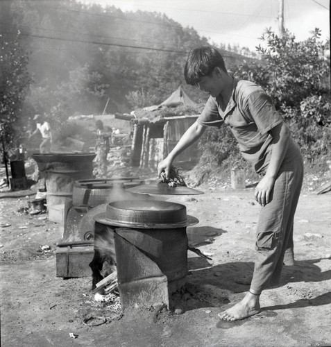 Man cooking in large pots
