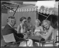 Alfonzo Bell, Elizabeth Tingle, Mrs. Miles Gray and Minnewa Bell playing cards at the Bel-Air Bay Club, Los Angeles, circa 1935-1936