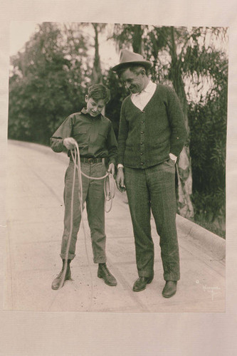 Will Rogers teaching Will Jr. how to rope