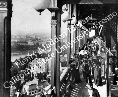 Fairgoers on balcony of Eiffel Tower