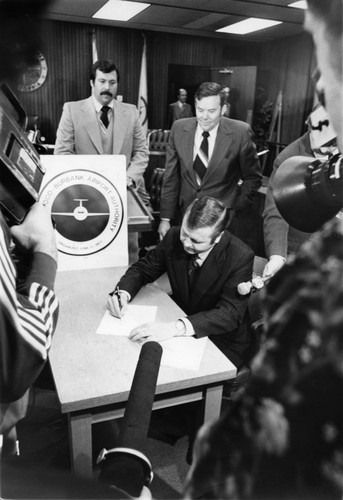 1977 - Hollywood-Burbank Airport Authority President William B. Rudell Signing Documents