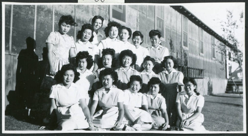 Photograph of Dagmar Quarnstrom and the hospital staff aides in front of the Manzanar hospital