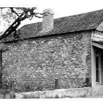 Unidentified building with stone wall, Columbia, CA