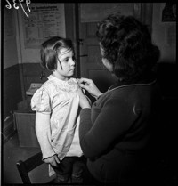 [Miscellaneous Numbered Negatives: girl being fitted for a new dress.]