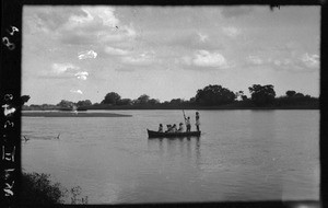 Small boat crossing a river, Mozambique, ca. 1940-1950