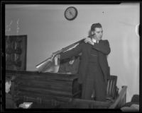 Leroy Saunderson stands in the witness box with a shotgun, Los Angeles, 1935