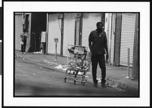 Homeless man with shopping cart filled with cans, Skid Row, Los Angeles, 1996