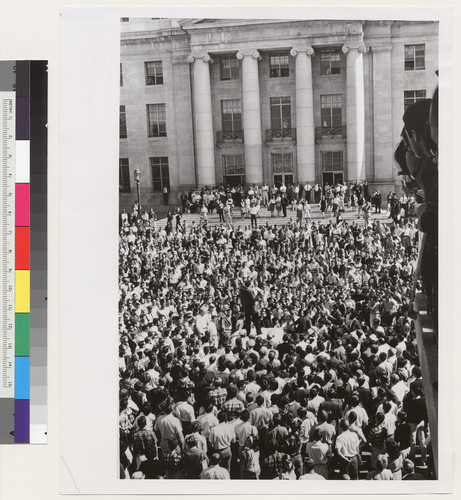 Surrounding a University police car in Sproul Hall Plaza on October 1, demonstrators listen to Mario Savio (standing on car roof) protest arrest of Jck Weinberg. Weinberg remained in the stranded car for 32 hours, until an agreement between President Kerr and protest leaders ended demonstration