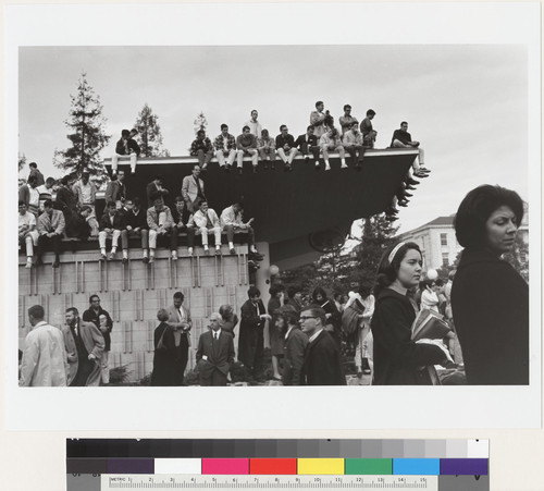 Students sitting on roof of Golden Bear Center during rally