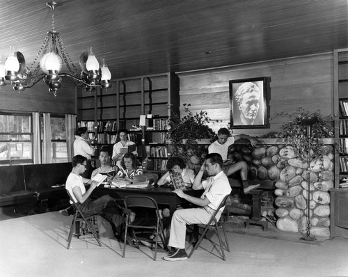 Gershon Kingsley leaning on library fireplace at Brandeis Camp Institute