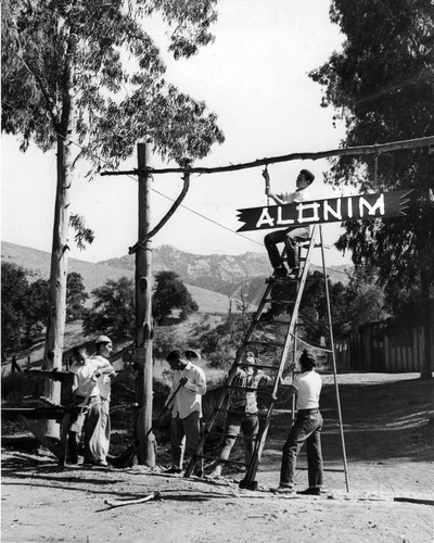 Alonim sign being hung