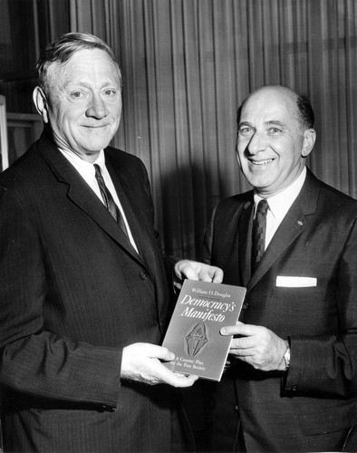 Supreme Court Justice William O. Douglas with his book, "Democracy's Manifesto"