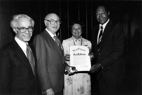 Mayor Tom Bradley gives a commendation to Mr. and Mrs. Jack Ostrow with Dr. David Lieber in attendance