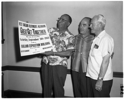Royal Towns holding sign for West Oakland Oldtimers Reunion next to two men