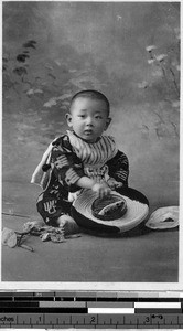 Child sitting on the floor, Japan, ca. 1920-1940