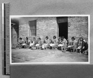 Spinning wool into yarn at Harwood Bible Training School, Fenyang, Shanxi, China, ca.1936-37