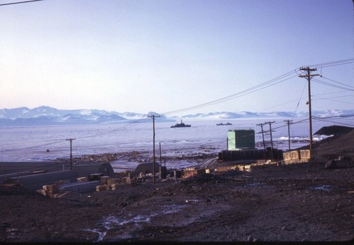Looking across McMurdo Sound at the Antarctic continent, with ships offshore McMurdo Station, Ross Island, Antarctica. 1964