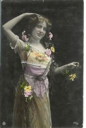 Postcard of a woman in Victorian dress in a country scene with flowers and roses