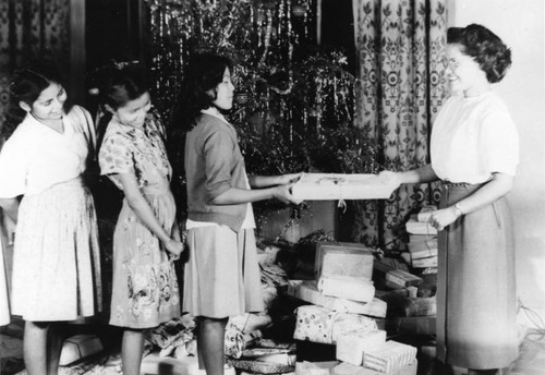 Navajo girls receiving Christmas gifts