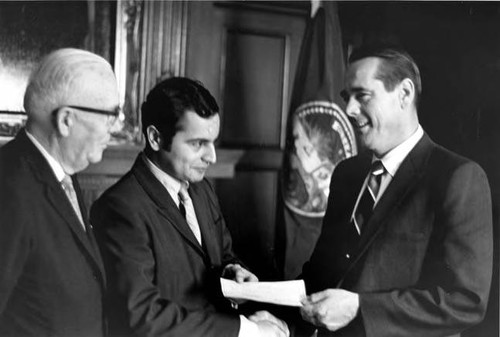 Two men receiving a check from Lt. Governor Reinecke