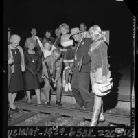 Las Vegas Mayor Oran K. Gragson pounding in silver spike at Los Angeles Union Station on 100th anniversary of Nevada's statehood, 1964