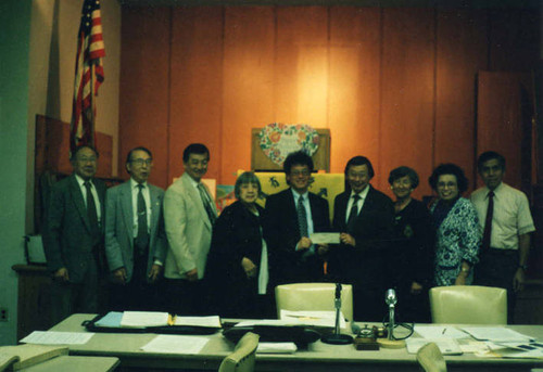 Los Angeles CACA receiving a donation. Lily Chan is next to president Winston Wu