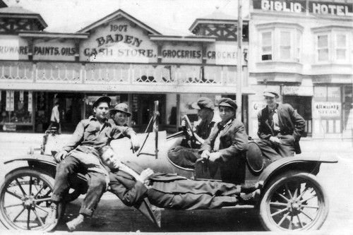 Working men in open car on Grand Avenue