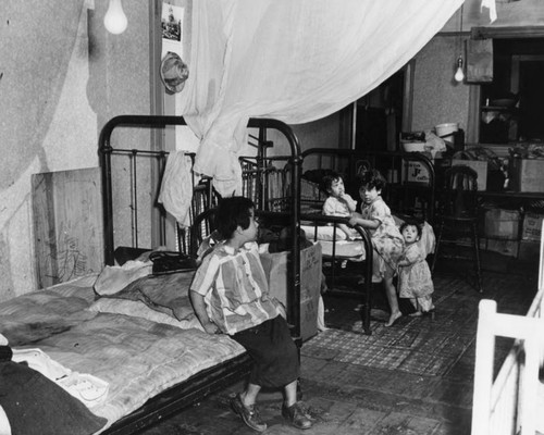 Four children in their slum home, Little Tokyo