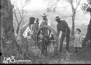 Alexis Thomas hooping a wheel with two African men, Elim, Limpopo, South Africa, ca. 1896-1911