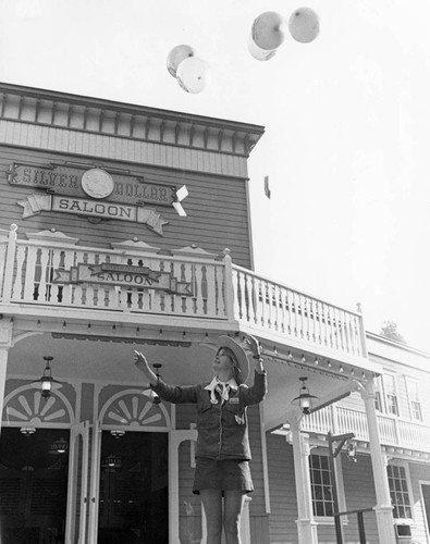 Frontier Village employee in front of the Silver Dollar Saloon