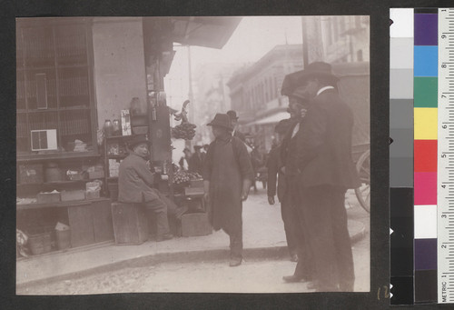 [Street Scene with Vendor Looking at Camera]