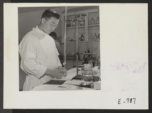 Tom Arasae, former California Bio-Chemistry student, performs a gastro analysis in the center hospital laboratory. Photographer: Parker, Tom Denson, Arkansas