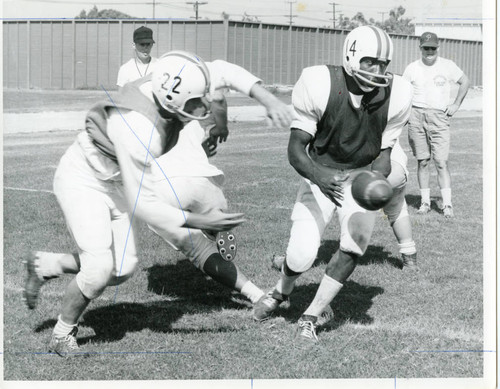 Football: Coach Denny Aria; Gene Wilson with the ball