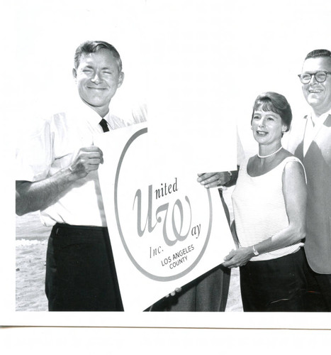 Unidentified people standing with United Way sign