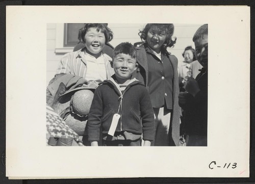 Byron, Calif.--Youngsters in this family of Japanese ancestry, from a farm in Contra Costa County, await bus for assembly center