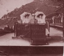Man and two women riding the gravity car, 1899-1928