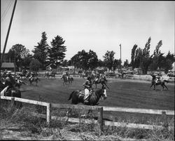 Members of the California Centaurs mounted junior drill team practicing a thread-the-needle maneuver at the Sonoma County Fairgrounds, Santa Rosa, California, 1946
