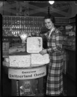 Jean Wilson poses with a block of Switzerland cheese, Los Angeles, 1930s